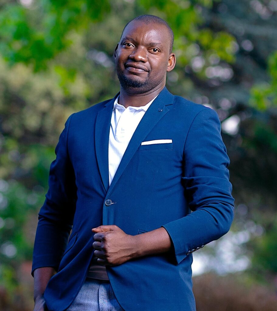 Gilson 1 Farmers International representative outdoors in a blue suit promoting sustainable agriculture.